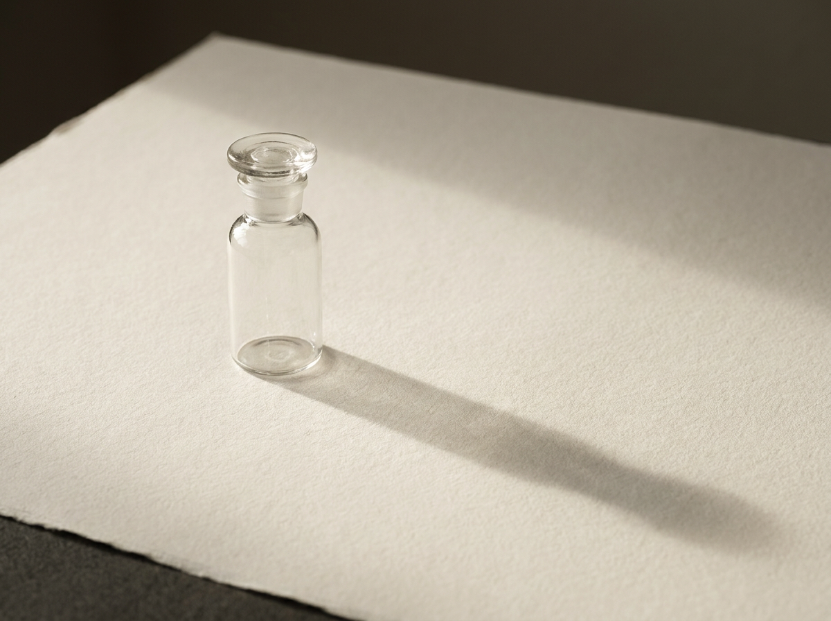A single glass laboratory vial photographed in editorial still life